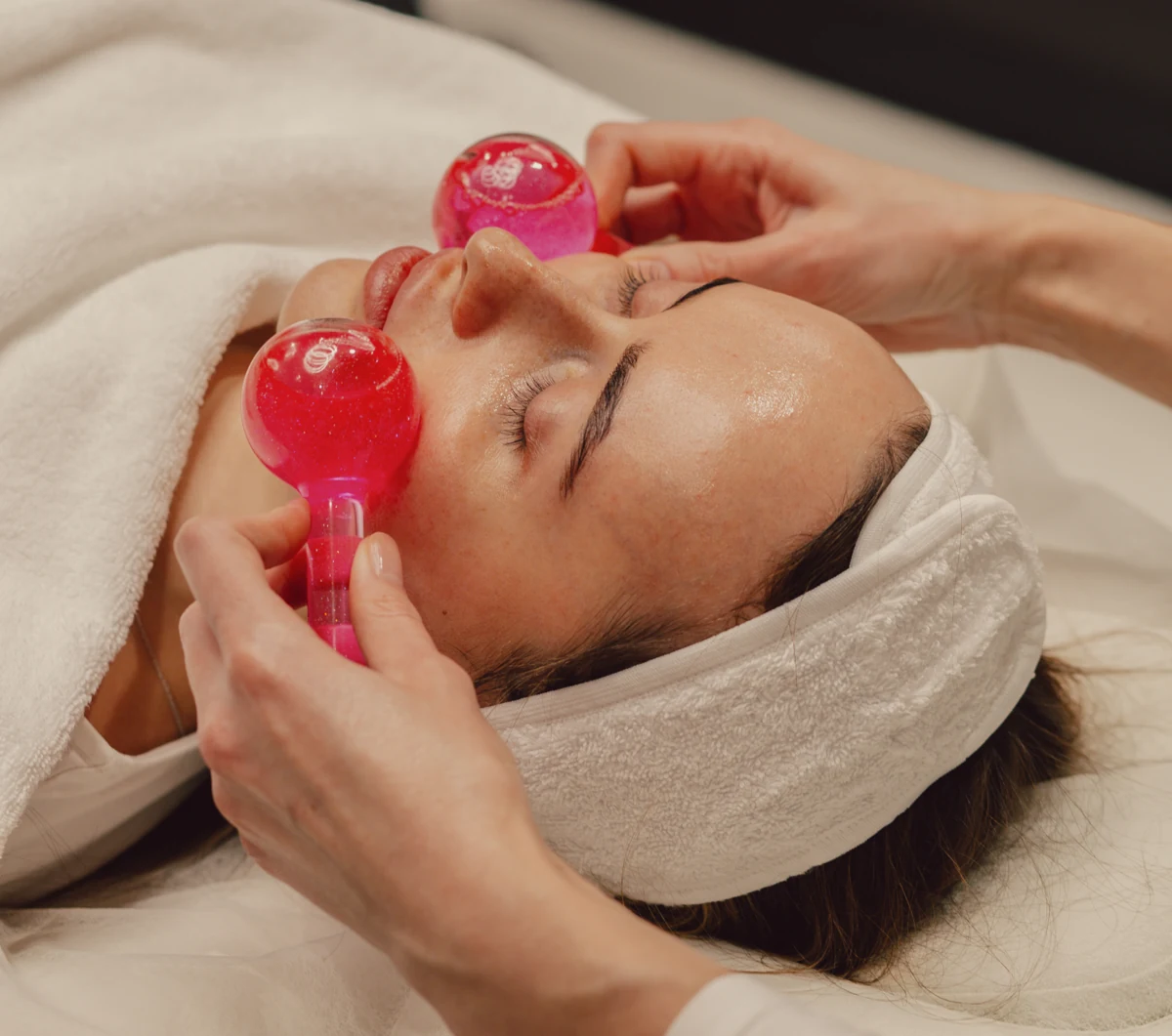 An Anywell facial treatment using pink cooling globes