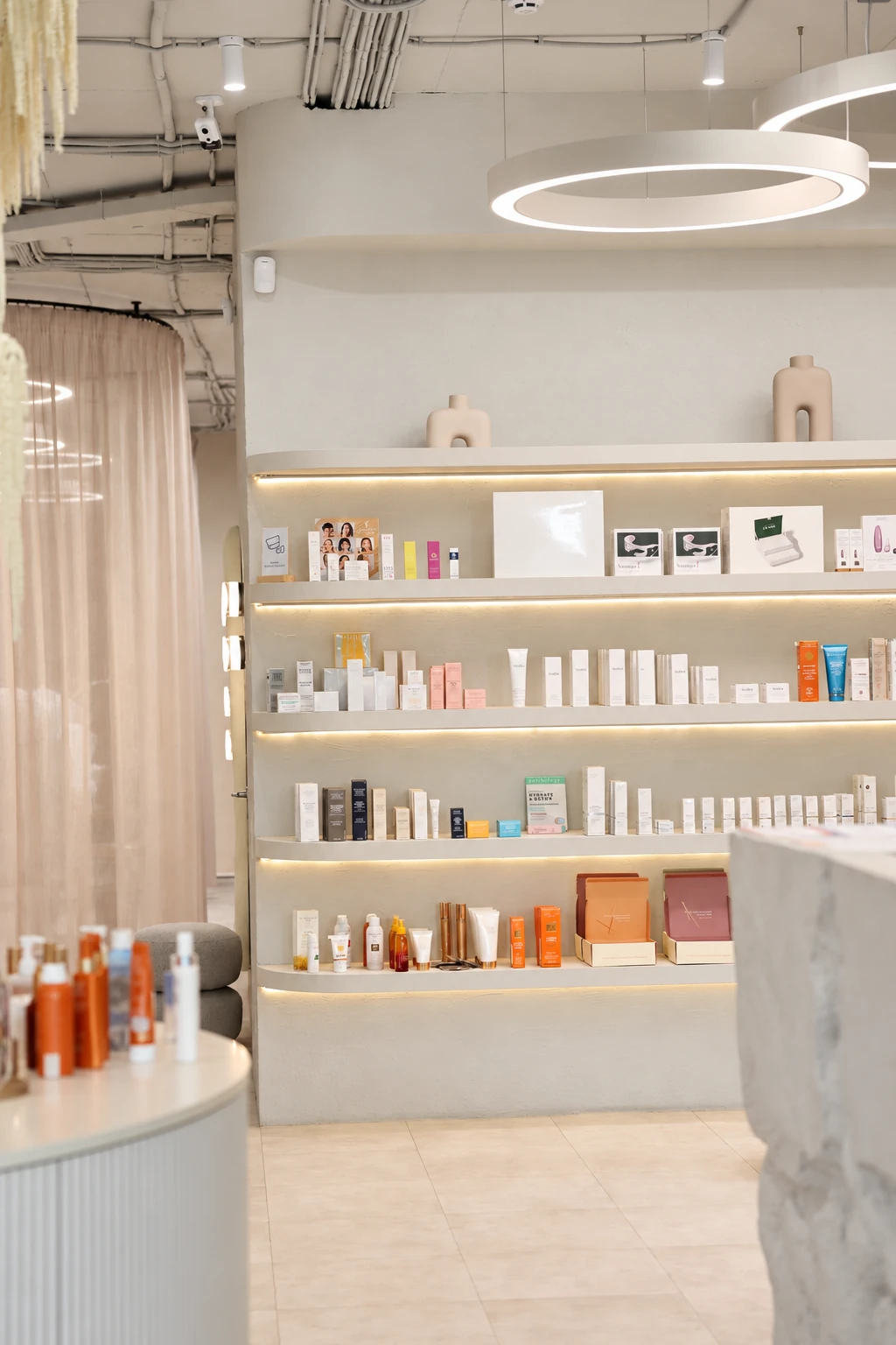 A view inside the current Anywell salon, with illuminated skincare shelves and warm interior details